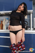 Brunette freshie posing topless in panties in the kitchen