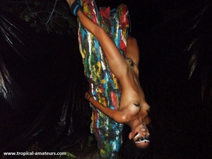 Hot tropical chick with her face in war paint bound upside down to the ritual pole - Picture 6