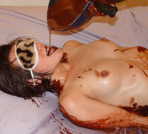 Brunette teen in a blindfold getting all oiled with chocolate - Picture 3