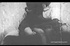 Horny vintage couple kissing and petting on the sofa.