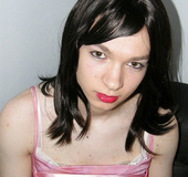 Pretty in glossy pink dress as an alluring crossdresser seductive poses