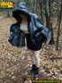 Shy teen wrapped up in a hooded black coat bends down to piss freely in