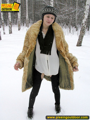 Cute white teen in fur coat, shirt and pantyhose takes an piss in the snow - Picture 1