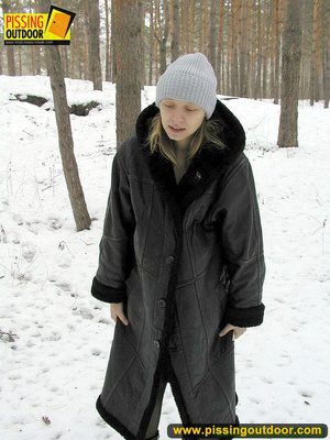 Pregnant young teen in jacket and pantyhose releases a stream of piss in the snow - Picture 1