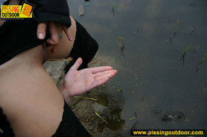 Two hot chicks on the open road piss outdoors on their hands and lick fingers - Picture 12
