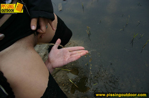 Two hot chicks on the open road piss outdoors on their hands and lick fingers - Picture 13