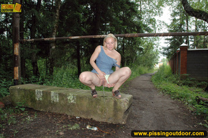 Hot blonde too kinky to take off panties as she slides pant to pee out n the woods - Picture 13