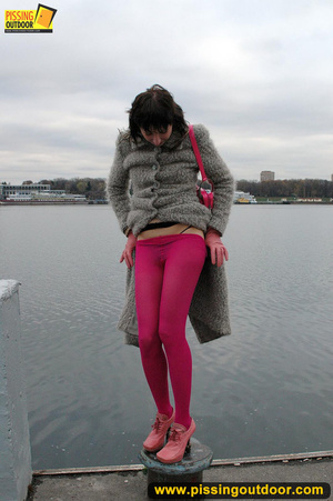 Babe walking outdoors makes a quick stop on an embankment to let out hot piss - XXXonXXX - Pic 3