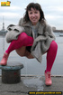 Babe walking outdoors makes a quick stop on an embankment to let out hot