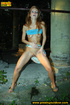 Redhead in blue raises her top and skirt to expose tits and piss outdoors