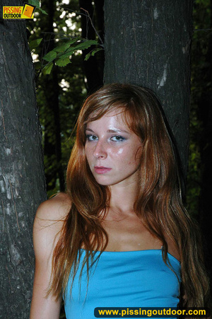 Redhead in blue raises her top and skirt to expose tits and piss outdoors at night - Picture 17