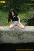 Pretty chick meets a pool and bends down to take a piss in it exposing