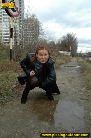 Pretty babe in black leather and stockings stop on road to piss outdoor on asphalt - XXXonXXX - Pic 14