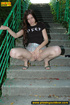Hot chick raises short skirt to piss on steps before cleaning pussy on