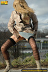 Sexy dressed blonde chick in boots walking on concrete road pissing outdoors