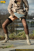 Sexy dressed blonde chick in boots walking on concrete road pissing outdoors