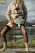 Sexy dressed blonde chick in boots walking on concrete road pissing outdoors