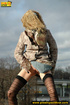 Sexy dressed blonde chick in boots walking on concrete road pissing outdoors