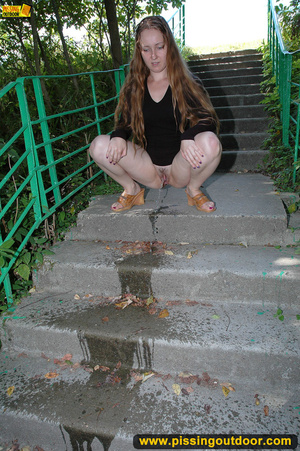 Smiling cute shapely chick in sexy black dress pisses along the park steps - XXXonXXX - Pic 11