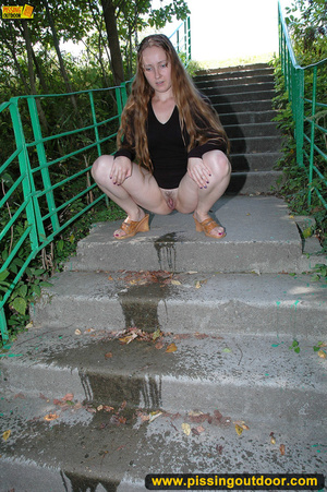 Smiling cute shapely chick in sexy black dress pisses along the park steps - XXXonXXX - Pic 12