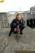 Girl in leather and stockings taking a stroll stops to piss outdoors in