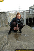 Girl in leather and stockings taking a stroll stops to piss outdoors in