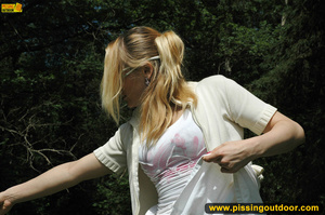 Sweet looking drinking blonde in glasses goes out to bend down to piss on wood - Picture 3