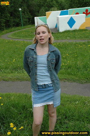 Hot young chick in public playground raise skirt and slide panty to piss on swing - Picture 1