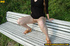 Cute naughty chick on a stroll stops to bend on park bench and spray piss