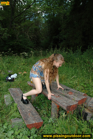 Long hair babe looking sweet climbs an old table in forest to spray hot piss - Picture 4