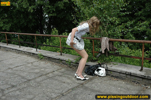 Smiling babe strips of stockings and shoes to pee hot piss on public concrete - XXXonXXX - Pic 9