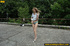 Smiling babe strips of stockings and shoes to pee hot piss on public concrete