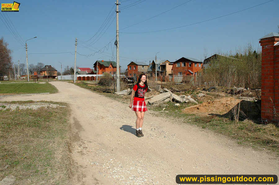 Hot girl in red raises short red skirt to piss hot piss on public road - XXXonXXX - Pic 1