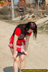 Hot girl in red raises short red skirt to piss hot piss on public road