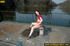 Naughty smiling young chick in red sits down and spreads legs to spray