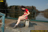 Naughty smiling young chick in red sits down and spreads legs to spray