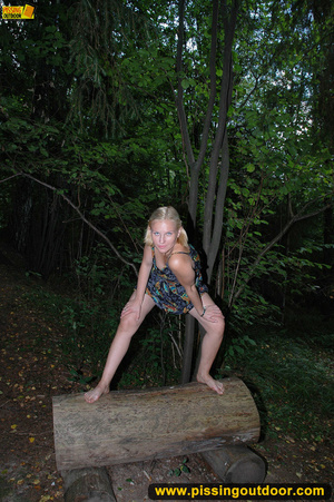 Horny blonde in cute short skirt takes walk in woods and pisses on tree trunk - Picture 2