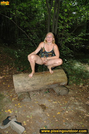 Horny blonde in cute short skirt takes walk in woods and pisses on tree trunk - Picture 5