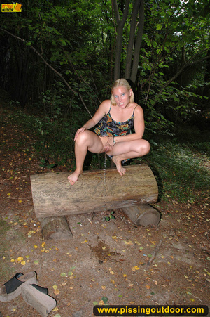 Horny blonde in cute short skirt takes walk in woods and pisses on tree trunk - Picture 6