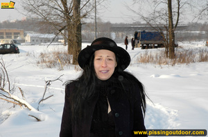 Lady in black coat and hat expose seductive ass and sprays hot pee on snow - Picture 1