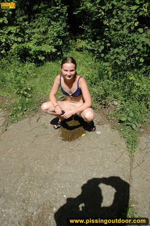 Lady in bikini removes panty along walkway in forest to piss in public - Picture 10