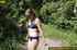 Lady in bikini removes panty along walkway in forest to piss in public