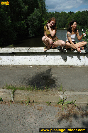 Two hot young chicks walking along river stop to pee in public - Picture 16