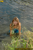 Cute girl in blue having fun in the water comes out to bend over to piss