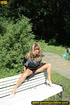 Pretty girl goes naughty pissing on white public bench close to forest