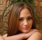 Exquisite young girl in fishnet pantyhose models her body, ass and pussy