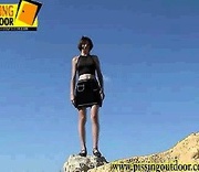 Sexy chick with cute tits climbs a sand hill and strips off clothes to spray piss