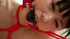 Pretty young Asian babe in red restraints gets tickled and pleasured erotically