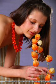 Athletic girl enjoys playing with flowers on her lovely body