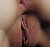 Curled hair girl adores to touch her body with pink feathers